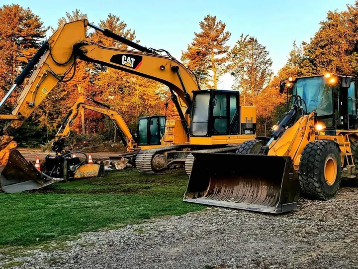 Yellow excavator and wheel loader on a commercial site in the fall