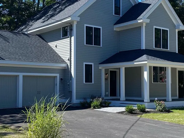 New house with a paved drive and a finished lawn
