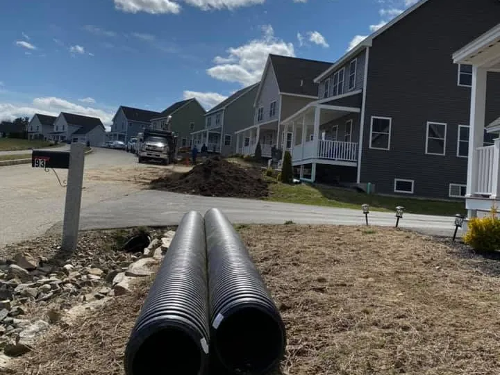 Two large corrugated pipes laid out on a new home site