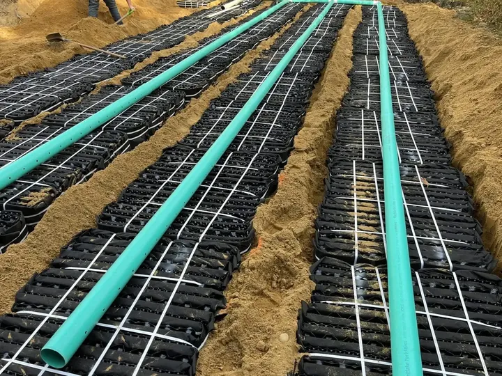 Septic chamber rows with green pipe laid over them
